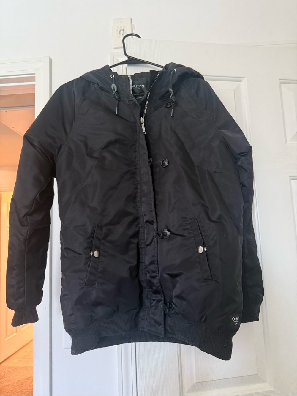 OBEY N-89 Propaganda black hooded bomber jacket with a button and zipper closure